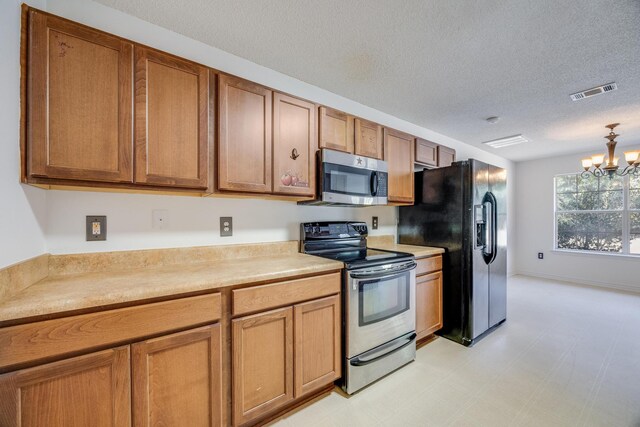 8180 Shooter Ln, Laurel Hill, FL 32567 - kitchen with appliances with stainless steel finishes, a chandelier, a textured ceiling, light countertops, and brown cabinets