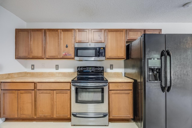 8180 Shooter Ln, Laurel Hill, FL 32567 - kitchen featuring appliances with stainless steel finishes and a textured ceiling