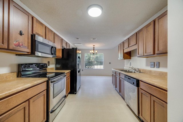 8180 Shooter Ln, Laurel Hill, FL 32567 - kitchen featuring a textured ceiling, a notable chandelier, sink, and stainless steel appliances