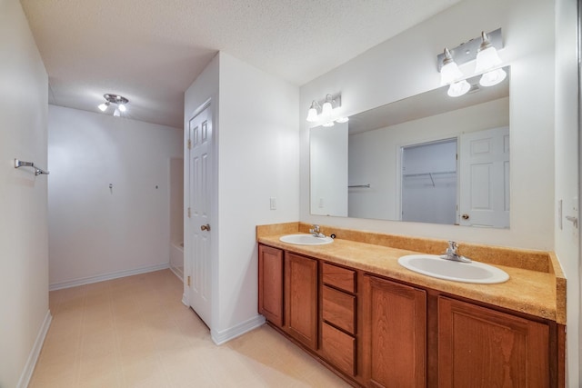 8180 Shooter Ln, Laurel Hill, FL 32567 - bathroom featuring a bathing tub, vanity, and a textured ceiling