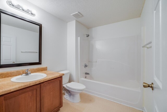 8180 Shooter Ln, Laurel Hill, FL 32567 - full bathroom featuring toilet, vanity, bathtub / shower combination, tile patterned floors, and a textured ceiling