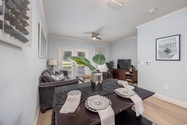 dining room with hardwood / wood-style flooring, ceiling fan, and crown molding