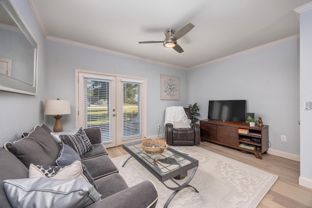 living room with crown molding, ceiling fan, and light wood-type flooring