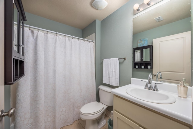 bathroom featuring tile patterned flooring, vanity, and toilet