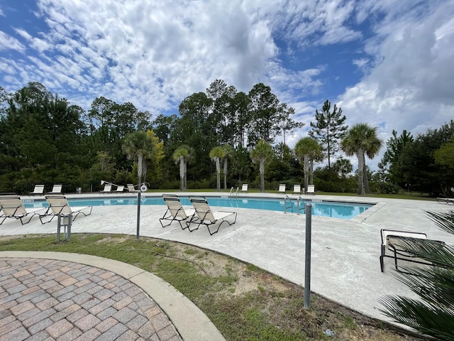 view of swimming pool featuring a patio area