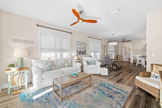 living room with dark hardwood / wood-style flooring, plenty of natural light, and ceiling fan