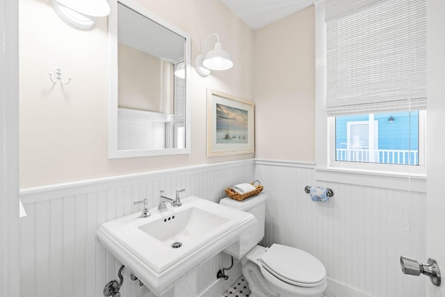 bathroom featuring tile patterned flooring, toilet, and sink