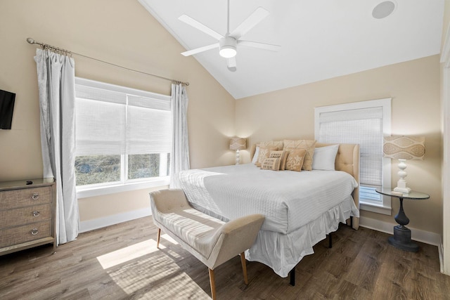 bedroom featuring hardwood / wood-style floors, ceiling fan, high vaulted ceiling, and multiple windows