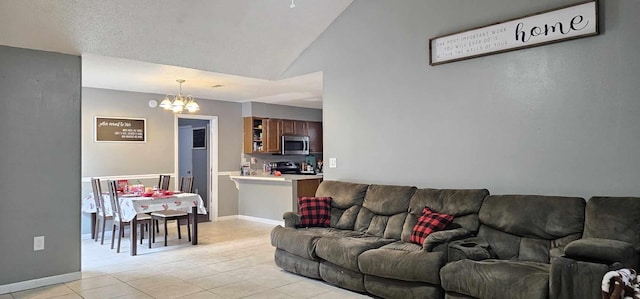 living room with a notable chandelier, lofted ceiling, and light tile patterned floors