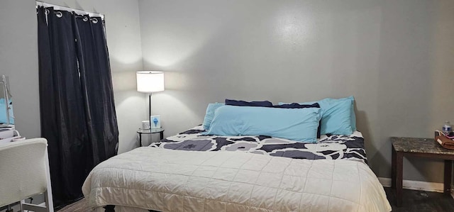 bedroom with hardwood / wood-style flooring