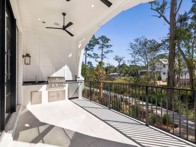 view of patio with grilling area, a balcony, ceiling fan, and sink