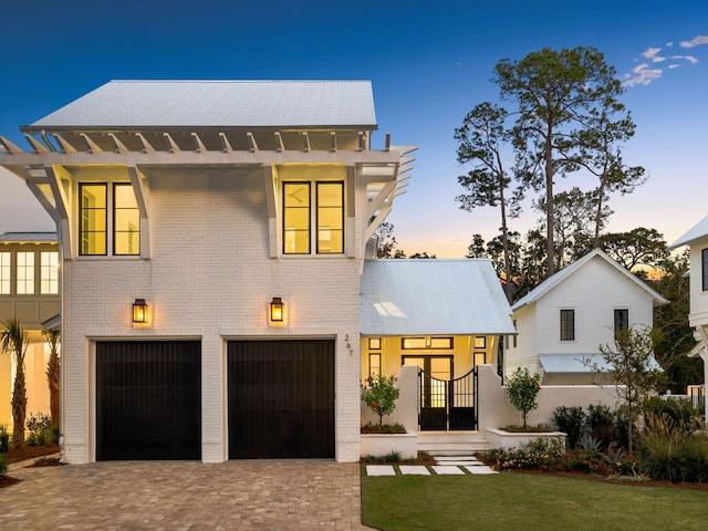 view of front of home featuring a garage and a yard