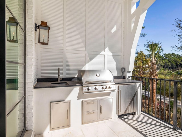 view of patio featuring area for grilling, exterior kitchen, and sink