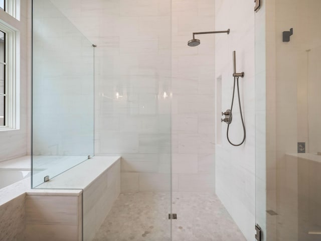 bathroom with shower with separate bathtub