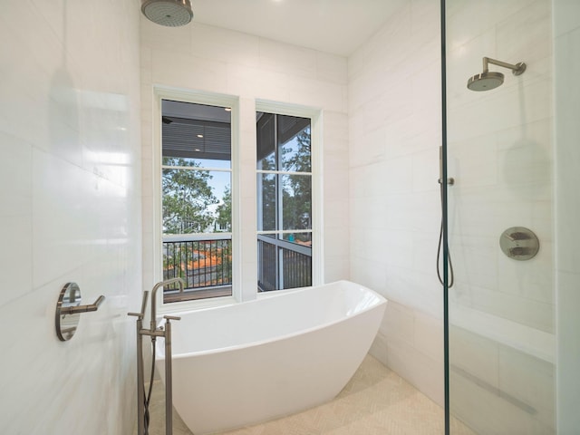 bathroom featuring tile walls and independent shower and bath