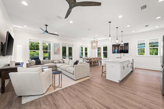 living room with ceiling fan, light wood-type flooring, and french doors