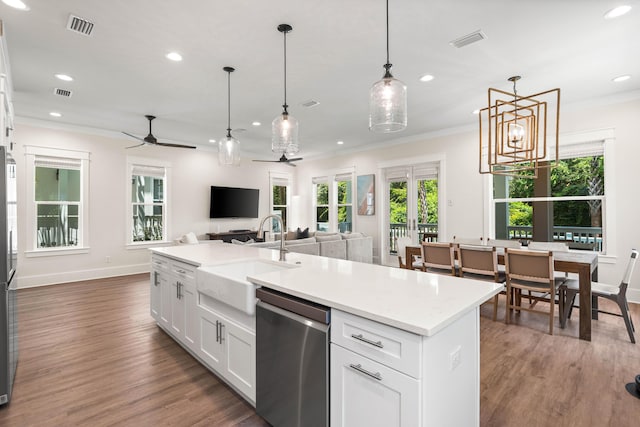 kitchen with pendant lighting, dishwasher, ceiling fan with notable chandelier, sink, and white cabinetry