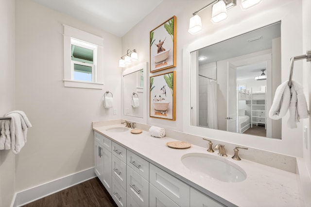 bathroom featuring wood-type flooring, vanity, and curtained shower