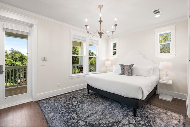 bedroom with multiple windows, dark hardwood / wood-style flooring, a chandelier, and ornamental molding