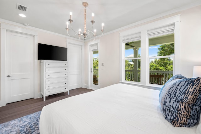 bedroom featuring dark hardwood / wood-style flooring, a chandelier, and ornamental molding