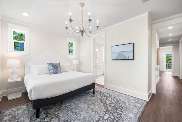 bedroom with connected bathroom, a chandelier, dark wood-type flooring, and ornamental molding