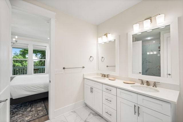 bathroom with a tile shower and vanity