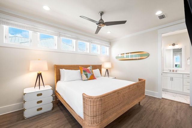 bedroom with connected bathroom, ceiling fan, crown molding, and dark hardwood / wood-style floors