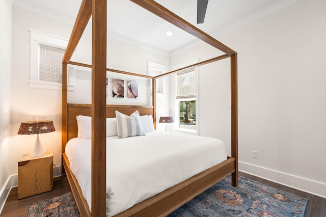 bedroom featuring crown molding, ceiling fan, and dark wood-type flooring