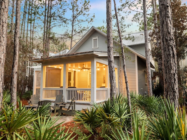 rear view of property featuring ceiling fan