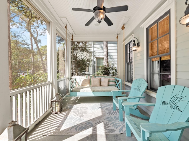 sunroom / solarium featuring ceiling fan