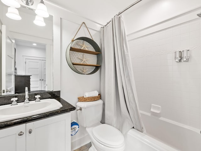 bathroom with shower / tub combo, vanity, and toilet