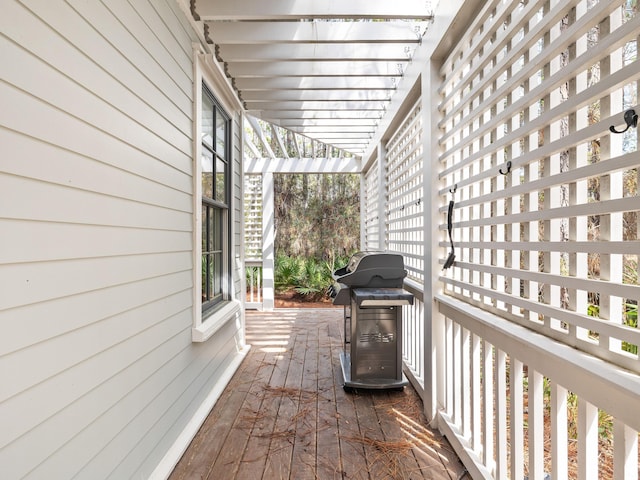 deck featuring grilling area and a pergola