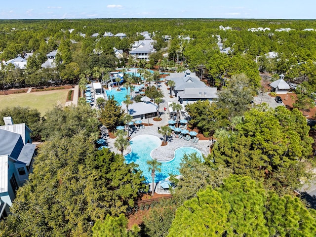 birds eye view of property featuring a view of trees