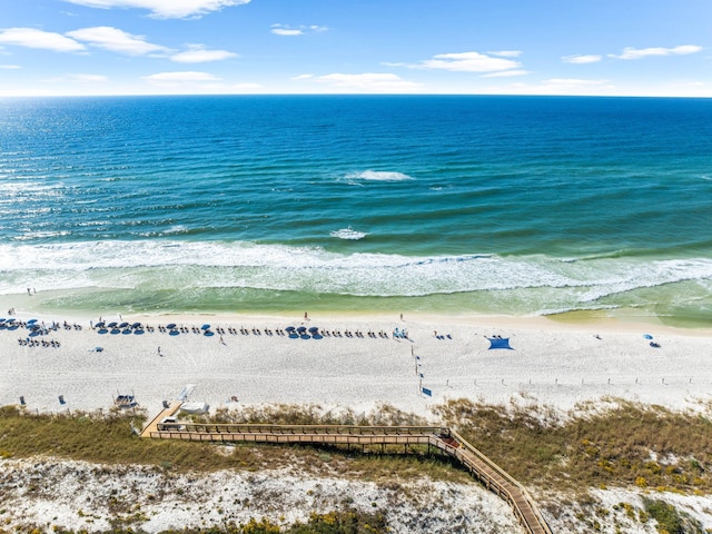 birds eye view of property featuring a beach view and a water view