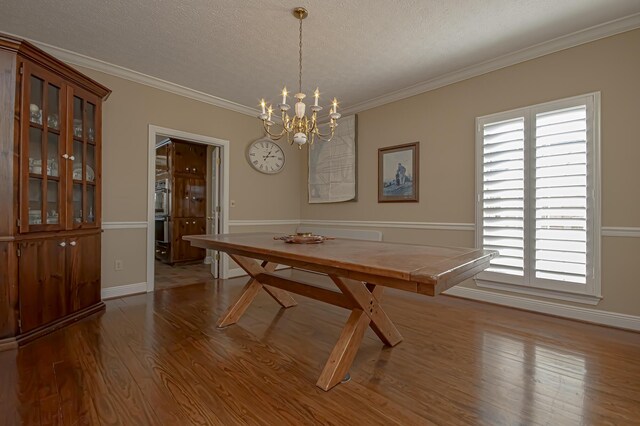 unfurnished dining area featuring crown molding, light wood-type flooring, a textured ceiling, and a wealth of natural light