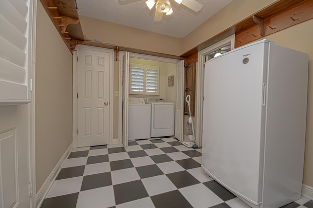 laundry area with a textured ceiling, separate washer and dryer, and ceiling fan