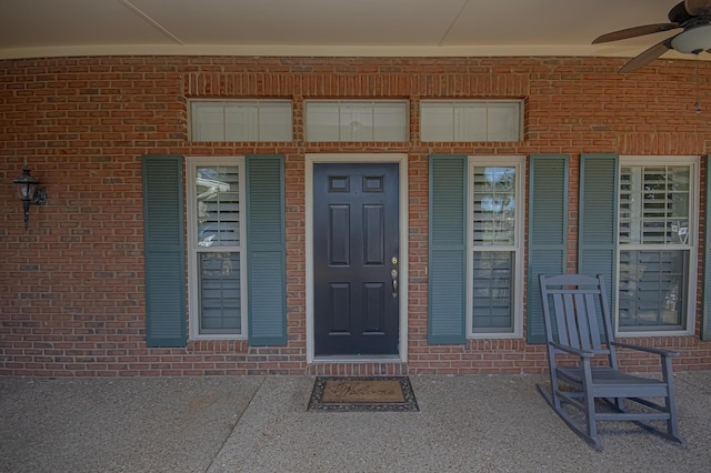 view of exterior entry with ceiling fan