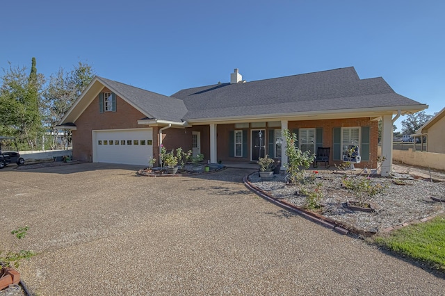 view of front facade featuring a porch and a garage