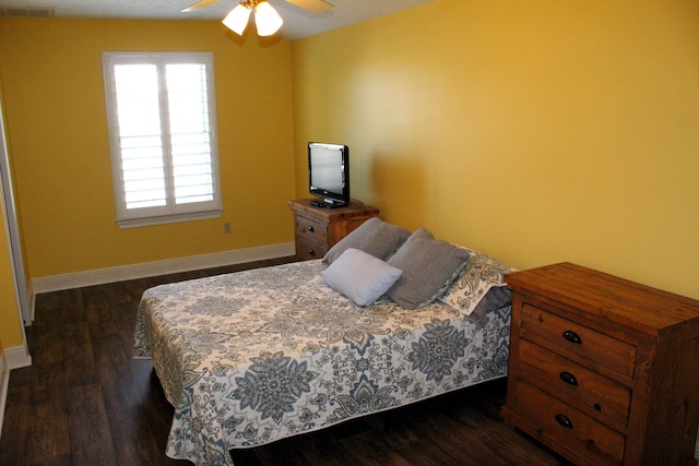 bedroom with dark hardwood / wood-style floors and ceiling fan