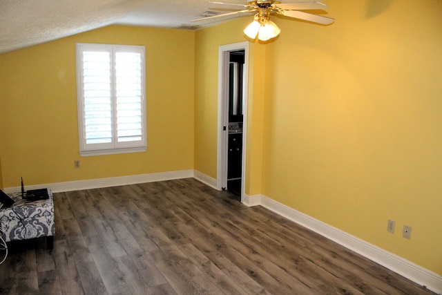 additional living space with dark hardwood / wood-style floors, ceiling fan, a textured ceiling, and vaulted ceiling