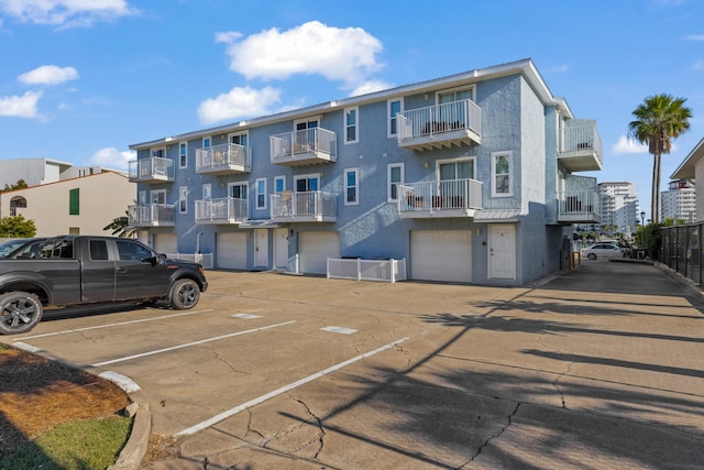 view of parking / parking lot featuring a garage