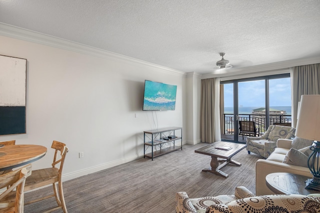10 Harbor Blvd Unit W528, Destin, FL 32541 - living room with crown molding, ceiling fan, a textured ceiling, and carpet flooring