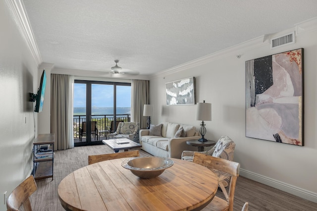 10 Harbor Blvd Unit W528, Destin, FL 32541 - living room with ornamental molding, a textured ceiling, and a ceiling fan