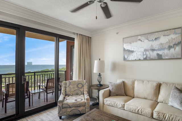 10 Harbor Blvd Unit W528, Destin, FL 32541 - living area with a water view, a ceiling fan, ornamental molding, light wood finished floors, and a textured ceiling