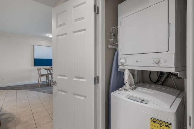 10 Harbor Blvd Unit W528, Destin, FL 32541 - washroom with stacked washer and clothes dryer, ornamental molding, and tile patterned flooring