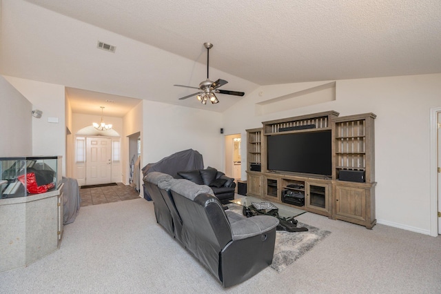 carpeted living room with ceiling fan with notable chandelier and vaulted ceiling