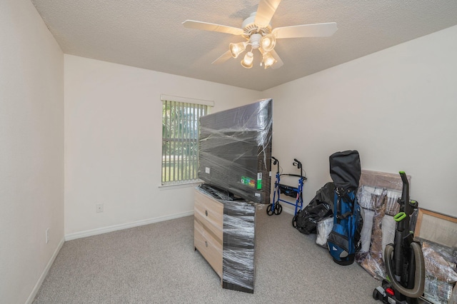 interior space featuring ceiling fan and a textured ceiling