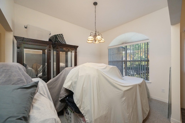 bedroom featuring carpet flooring, a chandelier, and vaulted ceiling