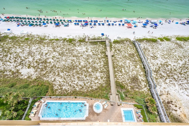 birds eye view of property featuring a beach view and a water view