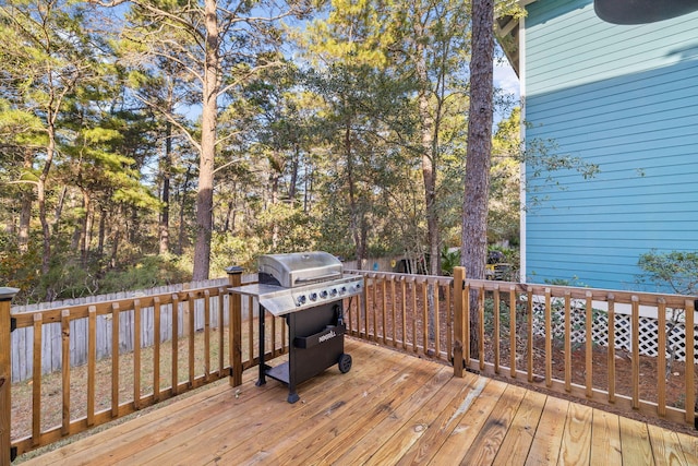 wooden deck featuring a grill